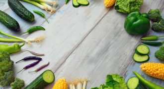 An assortment of fresh vegetables on a wooden table, perfect for healthy cooking.